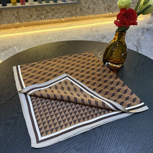 Folded brown geometric printed scarf showing its border and edge
