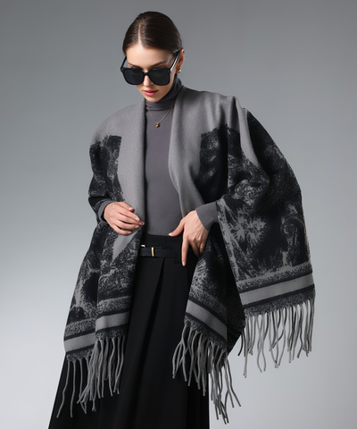 Grey star patterned winter shawl worn over a dark top